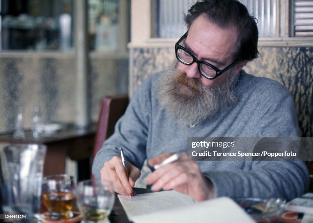 1972 Writing American scholar and poet John Berryman writing in a bar during a ...