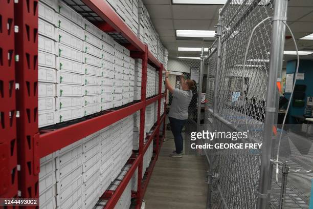 Utah County election worker pulls a box of ballots that have already been processed and counted in a fenced off secured area at the Utah County...