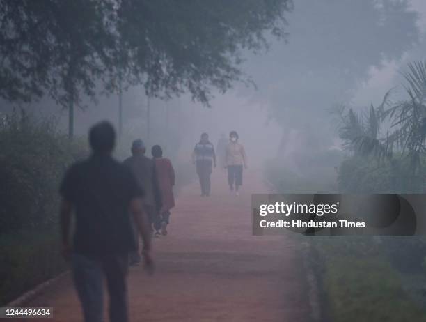 Morning walkers out in early morning winter smog, in Dwarka on November 4, 2022 in New Delhi, India. After a grim Thursday, NCR residents woke up to...