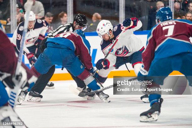 Evan Rodrigues of the Colorado Avalanche against Jack Roslovic of the Columbus Blue Jackets at the face-off during the 2022 NHL Global Series -...