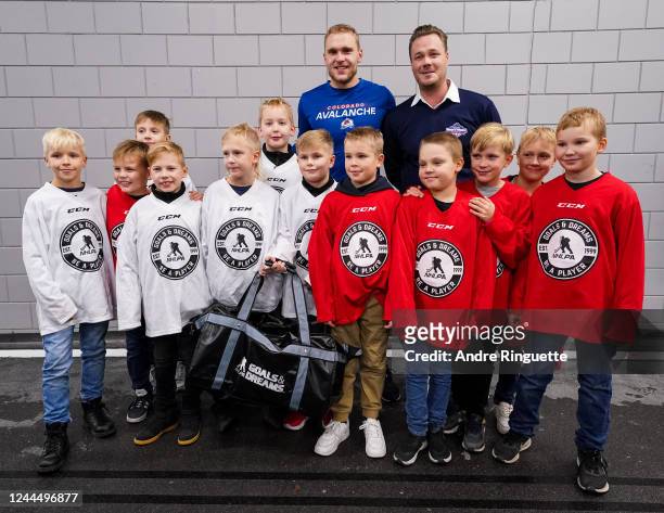Mikko Rantanen of the Colorado Avalanche poses for a photo with a group of local kids following a 6-3 win against the Columbus Blue Jackets during...