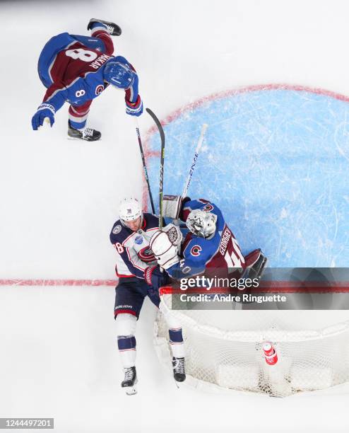 Boone Jenner of the Columbus Blue Jackets collides with Alexandar Georgiev of the Colorado Avalanche as his team-mate Cale Makar looks on in the...