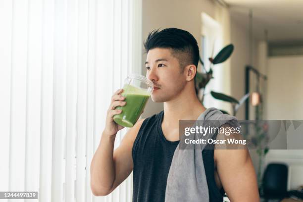 confident asian man drinking protein shake after workout - low carb diet stock pictures, royalty-free photos & images