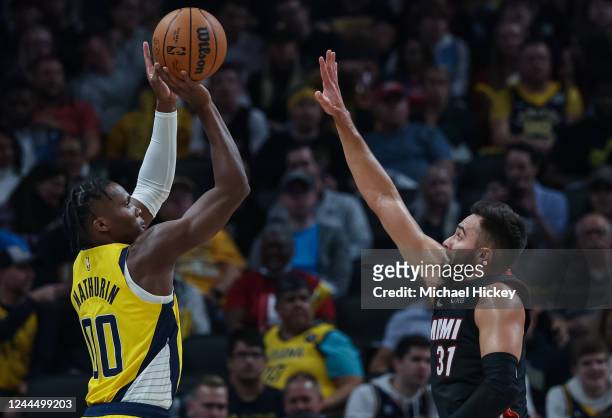 Bennedict Mathurin of the Indiana Pacers shoots the ball against Max Strus of the Miami Heat during the first half of the game at Gainbridge...