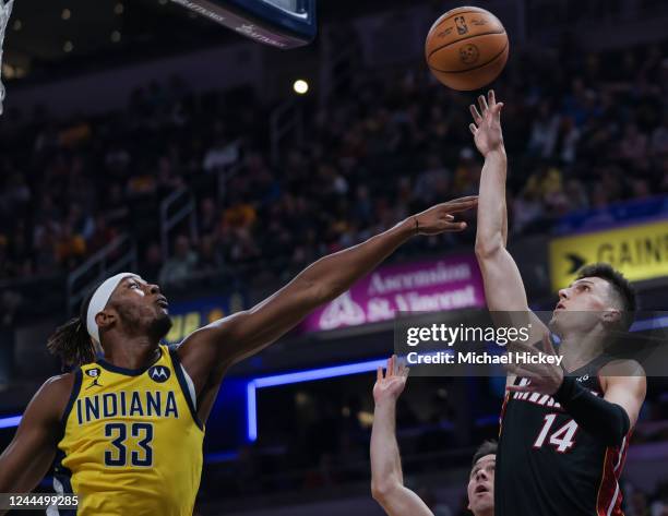 Tyler Herro of the Miami Heat shoots the ball against Myles Turner of the Indiana Pacers during the first half of the game at Gainbridge Fieldhouse...