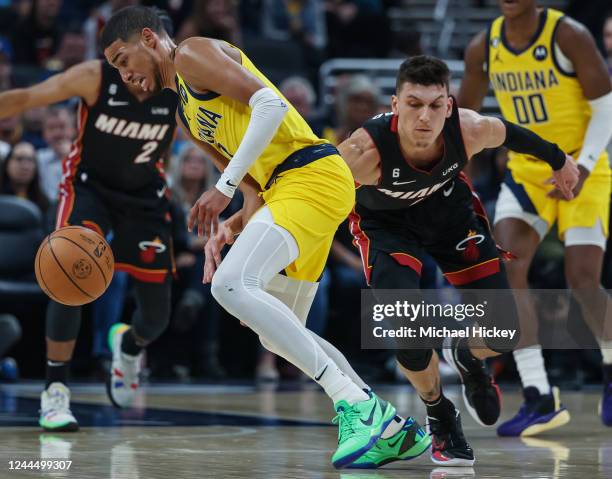 Tyrese Haliburton of the Indiana Pacer loses the ball against Tyler Herro of the Miami Heat during the first half of the game at Gainbridge...