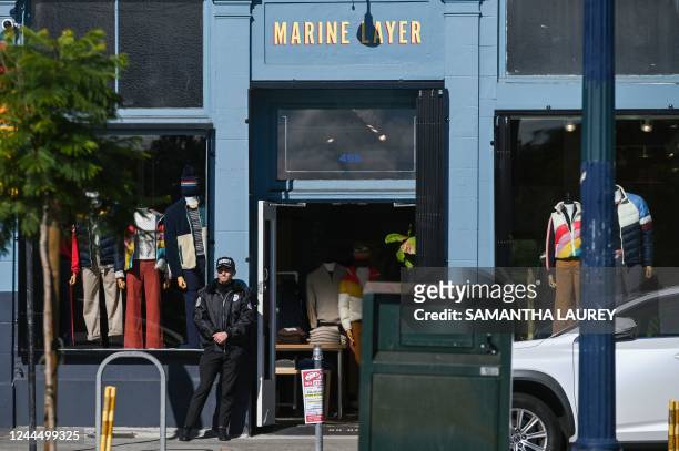 Security guard stands in front of Marine Layer store in the Hayes Valley neighborhood of San Francisco, California, on November 2, 2022. - When an...