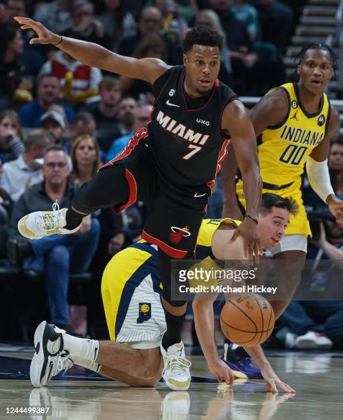Kyle Lowry of the Miami Heat hops over T.J. McConnell of the Indiana Pacers during the first half at Gainbridge Fieldhouse on November 4, 2022 in...
