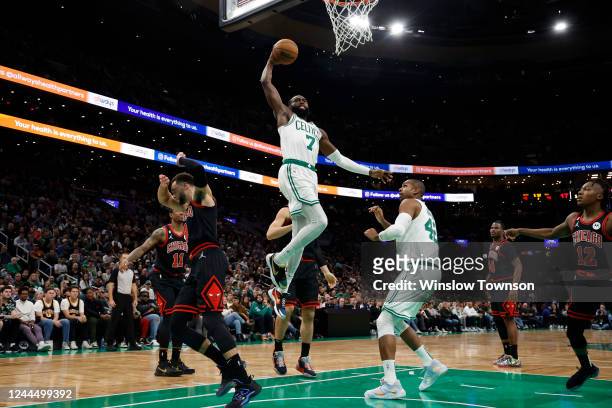 Jaylen Brown of the Boston Celtics goes in for a dunk as Zach LaVine of the Chicago Bulls moves out of the way during the second quarter of the game...