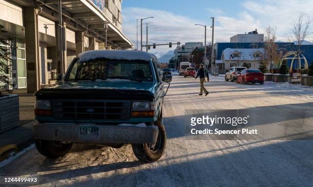 People walk through a snowy downtown on November 04, 2022 in Anchorage, Alaska. Early and absentee voting has begun in Alaska for the decisive...