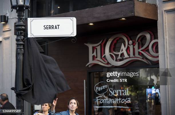 Street sign reading Serrat is seen outside El Cairo bar in downtown Rosario, Argentina, before the inauguration of "Paseo Fontanarrosa-Serrat", a...