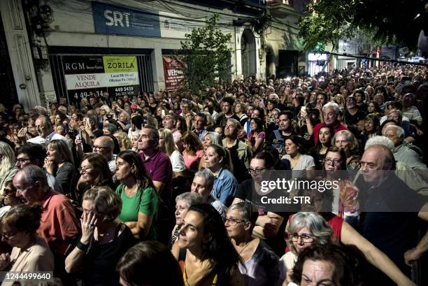 People attend the inauguration of the "Paseo Fontanarrosa-Serrat" at the corner of El Cairo bar in downtown Rosario, Argentina, on November 4, 2022.