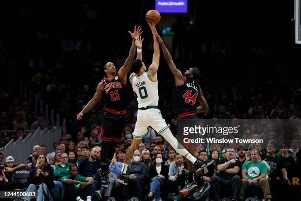 DeMar DeRozan of the Chicago Bulls and Patrick Williams cant stop Jayson Tatum of the Boston Celtics from taking a jump shot during the second half...