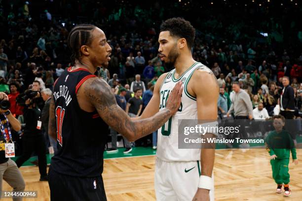 As Jayson Tatum of the Boston Celtics greets DeMar DeRozan of the Chicago Bulls after their game, Tatums son Duece, right comes to greet his dad at...