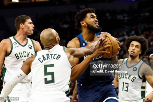 Karl-Anthony Towns of the Minnesota Timberwolves is fouled by Jevon Carter of the Milwaukee Bucks in the second quarter of the game at Target Center...