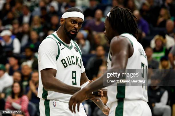 Jrue Holiday of the Milwaukee Bucks celebrates with teammate Bobby Portis after drawing a foul against the Minnesota Timberwolves in the third...