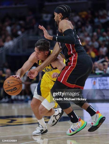 McConnell of the Indiana Pacers dribbles the ball against Gabe Vincent of the Miami Heat at Gainbridge Fieldhouse on November 4, 2022 in...