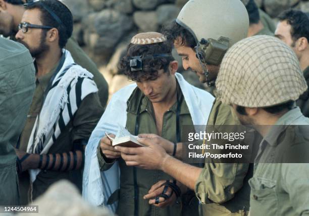 An Israeli soldier praying before seeing action against Syrian forces on the Golan Heights during the Yom Kippur War, circa October 1973.