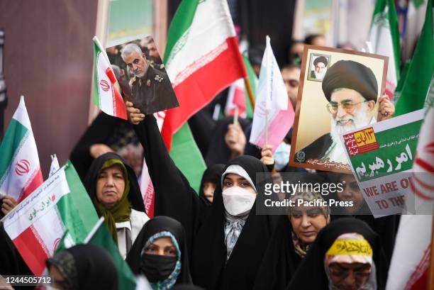 Woman holds a poster of the late Revolutionary Guard General Qassem Soleimani, who was killed in Iraq in a U.S. Drone attack in 2020. Iran on Friday...
