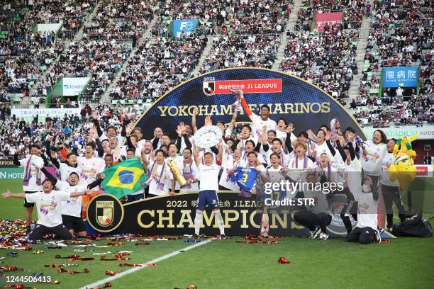 Players from Yokohama F Marinos celebrate after taking Japan's professional J-League football title following their 3-1 victory over Vissel Kobe to...