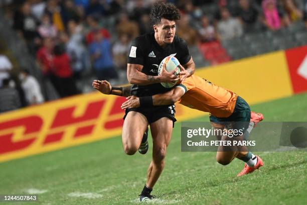 New Zealands Moses Leo is tackled by Australias Nick Malouf on the second day of the Hong Kong Sevens rugby tournament on November 5, 2022.