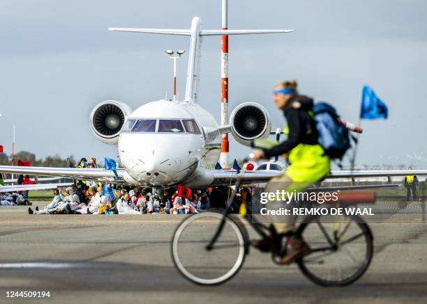 Milieudefensie, Extinction Rebellion, Greenpeace and other organisations members sit in front of an aircraft during a protest 'SOS for the climate'...