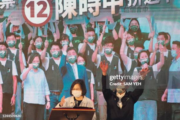 Chen Shih-chung , Taipei's mayoral candidate from the ruling Democratic Progressive Party , gestures onstage as Taiwanese President Tsai Ing-wen...