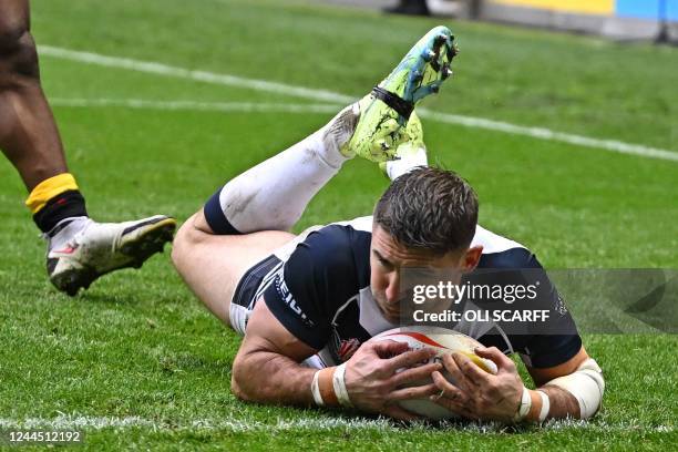 England's Tommy Makinson dives over the line to score England's second try during the 2021 rugby league World Cup men's Quarter Final match between...