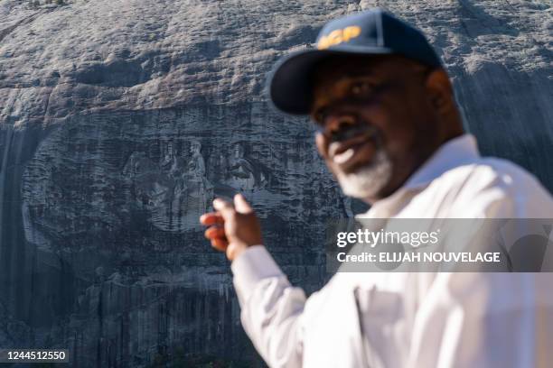 Lance Hammonds, President of the NAACP DeKalb branch, points to the Confederate Memorial Carving at Stone Mountain Park on October 15 in Stone...