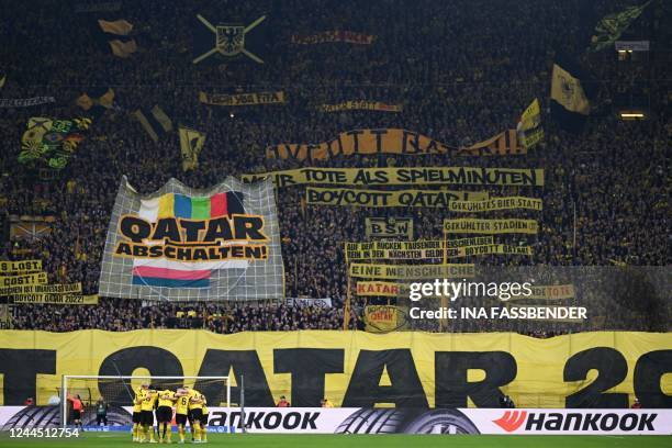 Dortmund fans display banners demanding a boycott of the 2022 FIFA World Cup in Qatar during the German first division Bundesliga football match...