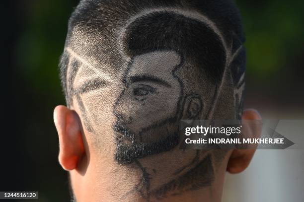 Chirag Khilare, a fan of cricketer Virat Kohli, sports a hairdo in the likeness of the cricketer during an event to celebrate his birthday in Mumbai...