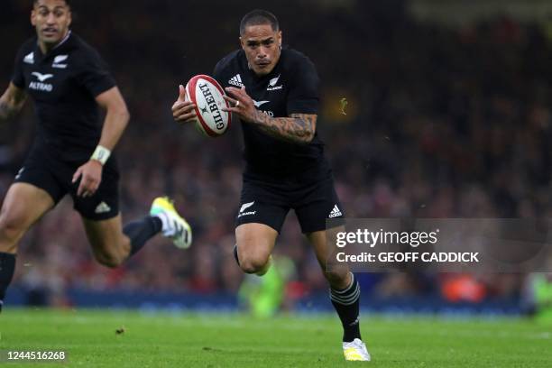 New Zealand's scrum-half Aaron Smith runs in a try during the Autumn International rugby union match between Wales and New Zealand at the...