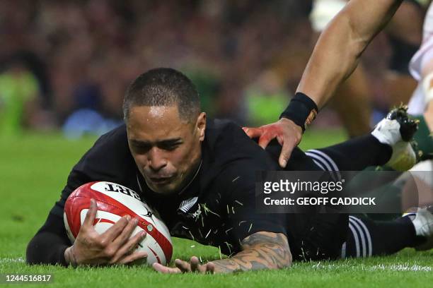 New Zealand's scrum-half Aaron Smith dives over the line to score his second during the Autumn International rugby union match between Wales and New...