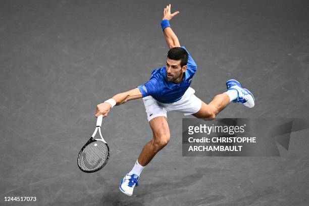 Serbia's Novak Djokovic returns the ball during the men's singles semi-final tennis match between Serbia's Novak Djokovic and Greece's Stefanos...
