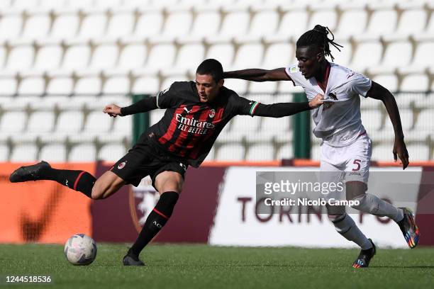Marko Lazetic of AC Milan U19 competes for the ball with Ange Caumenan N'Guessan of Torino FC U19 during the Primavera 1 football match between...