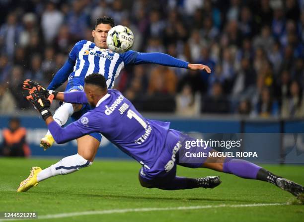 Porto's Brazilian midfielder Evanilson Barbosa kicks the ball to score a goal to Pacos de Ferreira's Brazilian goalkeeper Jordi Martins during the...