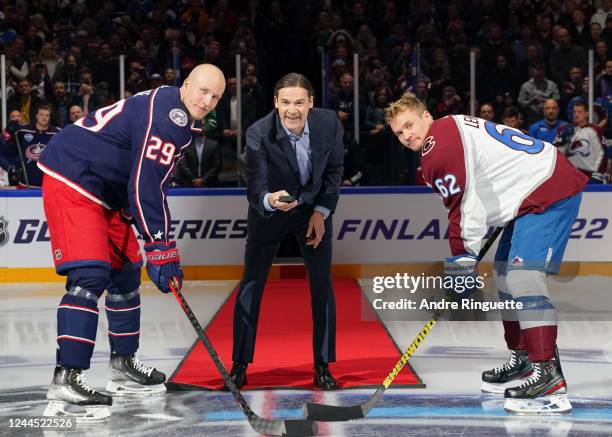 Patrik Laine of Columbus Blue Jackets and Artturi Lehkonen of the Colorado Avalanche take part in a ceremonial face-off dropped by Teppo Numminen...