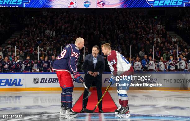 Patrik Laine of Columbus Blue Jackets and Artturi Lehkonen of the Colorado Avalanche take part in a ceremonial face-off dropped by Teppo Numminen...