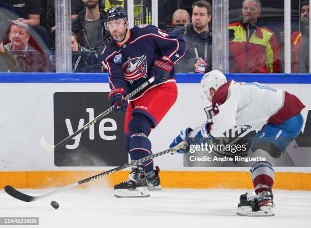 Erik Gudbranson of the Columbus Blue Jackets passes the puck against Andrew Cogliano of the Colorado Avalanche during the 2022 NHL Global Series...