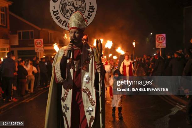 Members of various bonfire societies take part in the torch lit procession through the streets of Edenbridge, south of London on November 5, 2022. -...