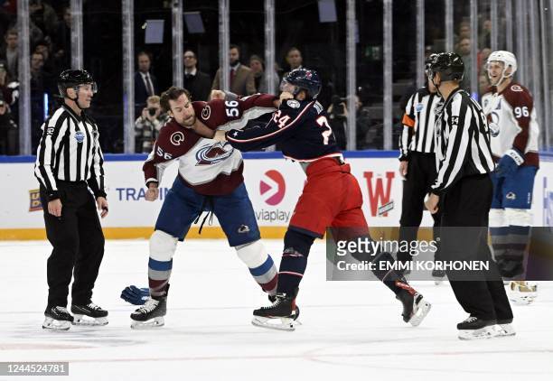 Colorado Avalanche's Kurtis MacDermid and Columbus Blue Jackets' Mathieu Olivier exchange punches during the 2022 NHL Global Series ice hockey match...