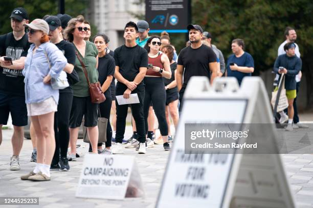 People wait in line on the final day of early voting at a polling location at Bank of America Stadium on November 5, 2022 in Charlotte, North...