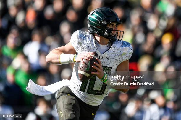 Quarterback Bo Nix of the Oregon Ducks rolls out of the pocket to pass against the Colorado Buffaloes in the first quarter of a game at Folsom Field...