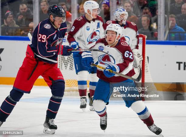 Artturi Lehkonen of the Colorado Avalanche battles for position with Patrik Laine of the Columbus Blue Jackets during the 2022 NHL Global Series...