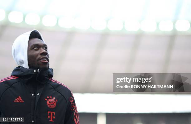 Bayern Munich's Canadian midfielder Alphonso Davies enters the pitch ahead of the start of the German first division Bundesliga football match...