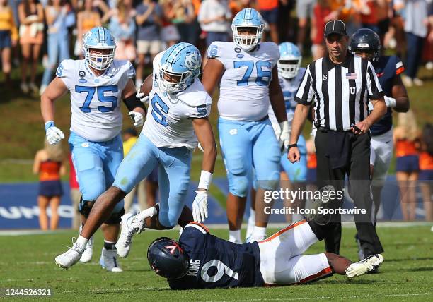 North Carolina Tar Heels wide receiver J.J. Jones hauls in a pass then attempts to avoid Virginia Cavaliers defensive back Coen King during a college...