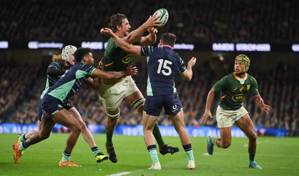 Dublin , Ireland - 5 November 2022; Eben Etzebeth of South Africa offloads to team-mate Kurt-Lee Arendse, despite the tackles of Mack Hansen, Robert Baloucoune and Hugo Keenan of Ireland, for Arendse to score his side's second try during the Bank of Ireland Nations Series match between Ireland and South Africa at the Aviva Stadium in Dublin. (Photo By Brendan Moran/Sportsfile via Getty Images)