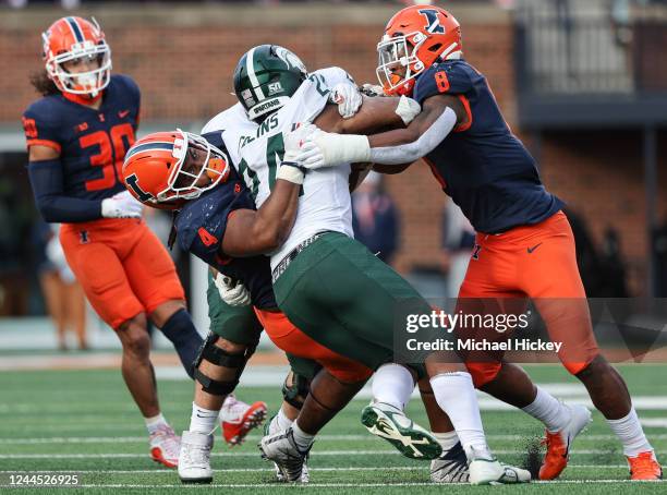 Jer'Zhan Newton and Tarique Barnes of the Illinois Fighting Illini make the tackle on Elijah Collins of the Michigan State Spartans during the first...