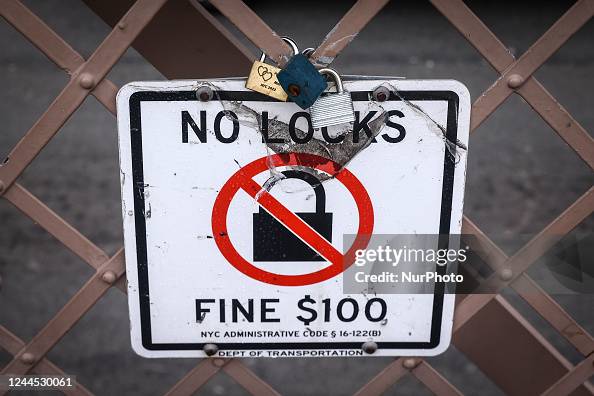 No Lock In No Locks sign is seen on the pedestrian walkway at Brooklyn Bridge in ...