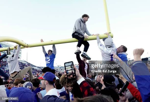 Fans attempt to pull down a goal post after Kansas 37-16 win against the Oklahoma State Cowboys at David Booth Kansas Memorial Stadium on November 5,...
